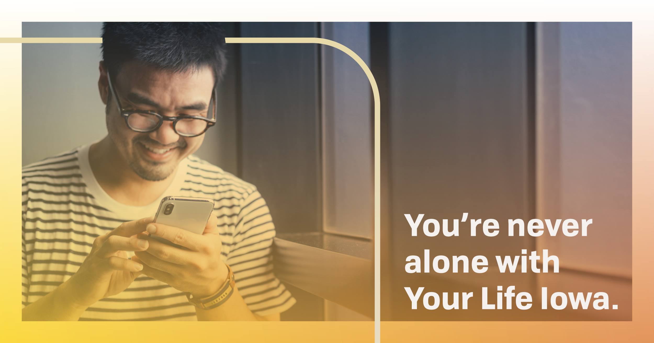 Man smiling and looking at cell phone.