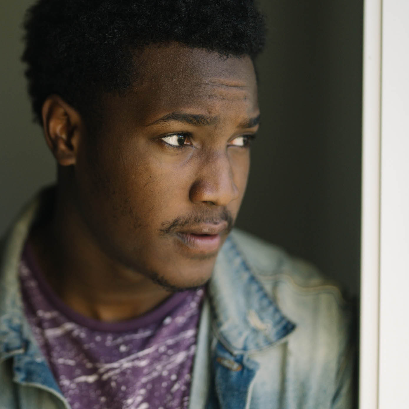 Young black man looking concerned.