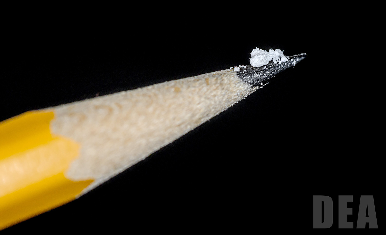 Two milligrams of white powder on the tip of a pencil.