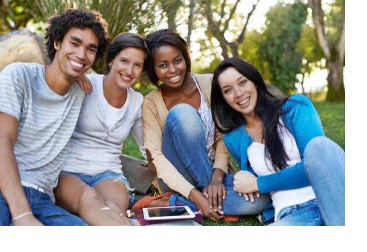 Four college students sitting outside.