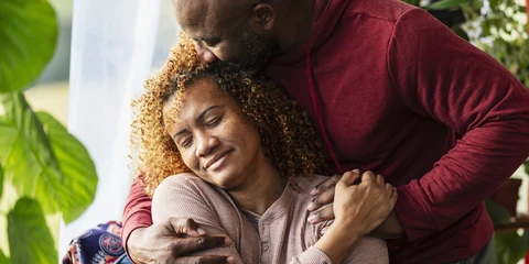 Husband and wife hugging and showing support