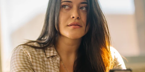 Woman texting Your Life Iowa number