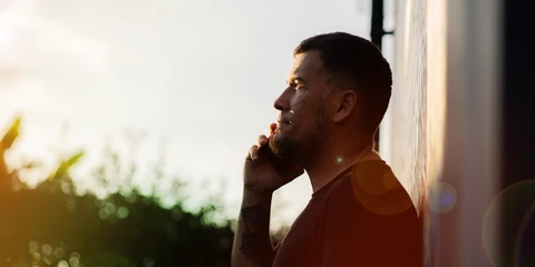 adult man rural setting talking on phone