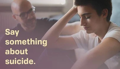 a parent and teen having a serious conversation while seated on the floor