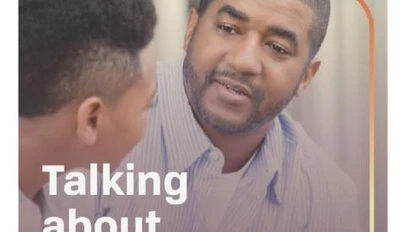 an adult talking seriously with a young adult