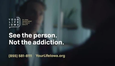 blurry image of a person talking with another person with text overlay related to this campaign