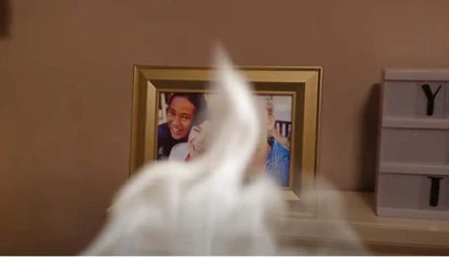 smoke rising in front of a framed family portrait