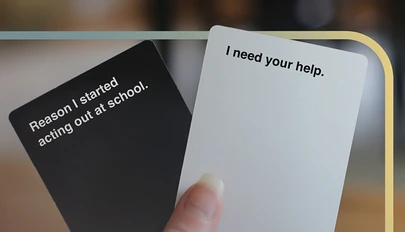a hand holding two cards with text on them