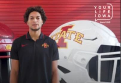 Jayden Higgins in front of a football helmet