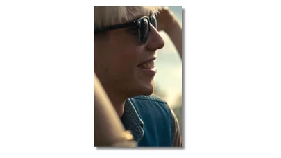 profile of a person wearing sunglasses, smiling