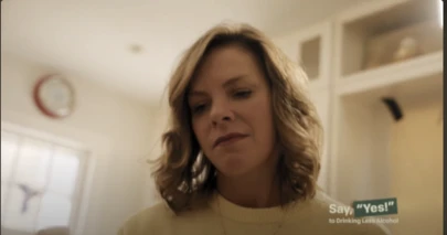 a woman seated in a beige room