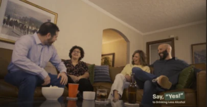 four adults sitting together in a living room