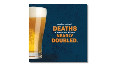 foamy glass of beer with orange and white text