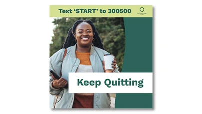 woman smiling and holding a coffee cup