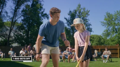Thumbnail photo of a 20-something man comforting a young girl when she misses the baseball at a family outdoor gathering