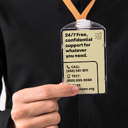 Person holding ID badge with YLI contact information
