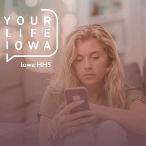 Teen girl sitting on couch and looking at her cell phone.