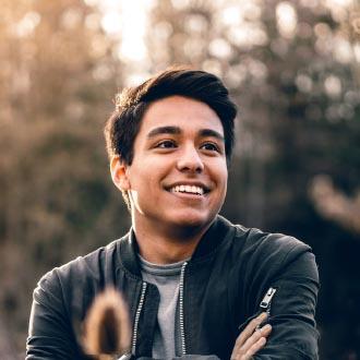 Man smiling with trees in the background