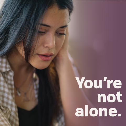 Woman looking concerned. Text says You're Not Alone."