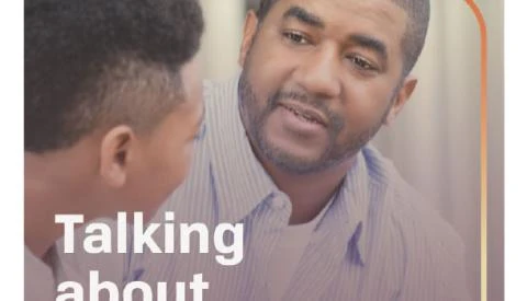 an adult talking seriously with a young adult