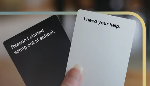 a hand holding two cards with text on them