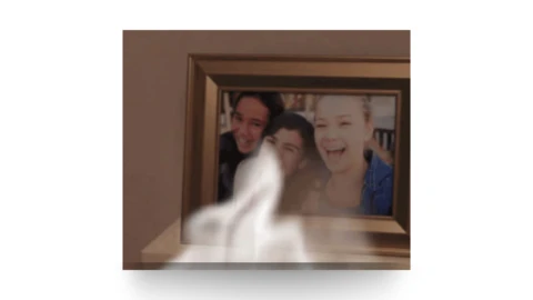 a framed family portrait with smoke in front of it