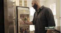 Image of "joe" in the kitchen opening the fridge.