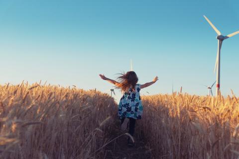 Girl running in wheat field