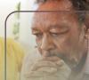 A man leans his head on his hands
