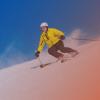 Adult man skiing down a snow-covered hill.