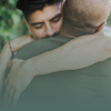 Two adult men hugging