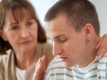 Parent talking to teen son in serious conversation