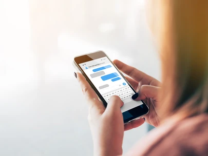 Woman texting Your Life Iowa number