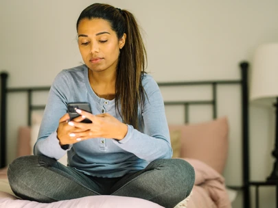 young adult woman looking at phone